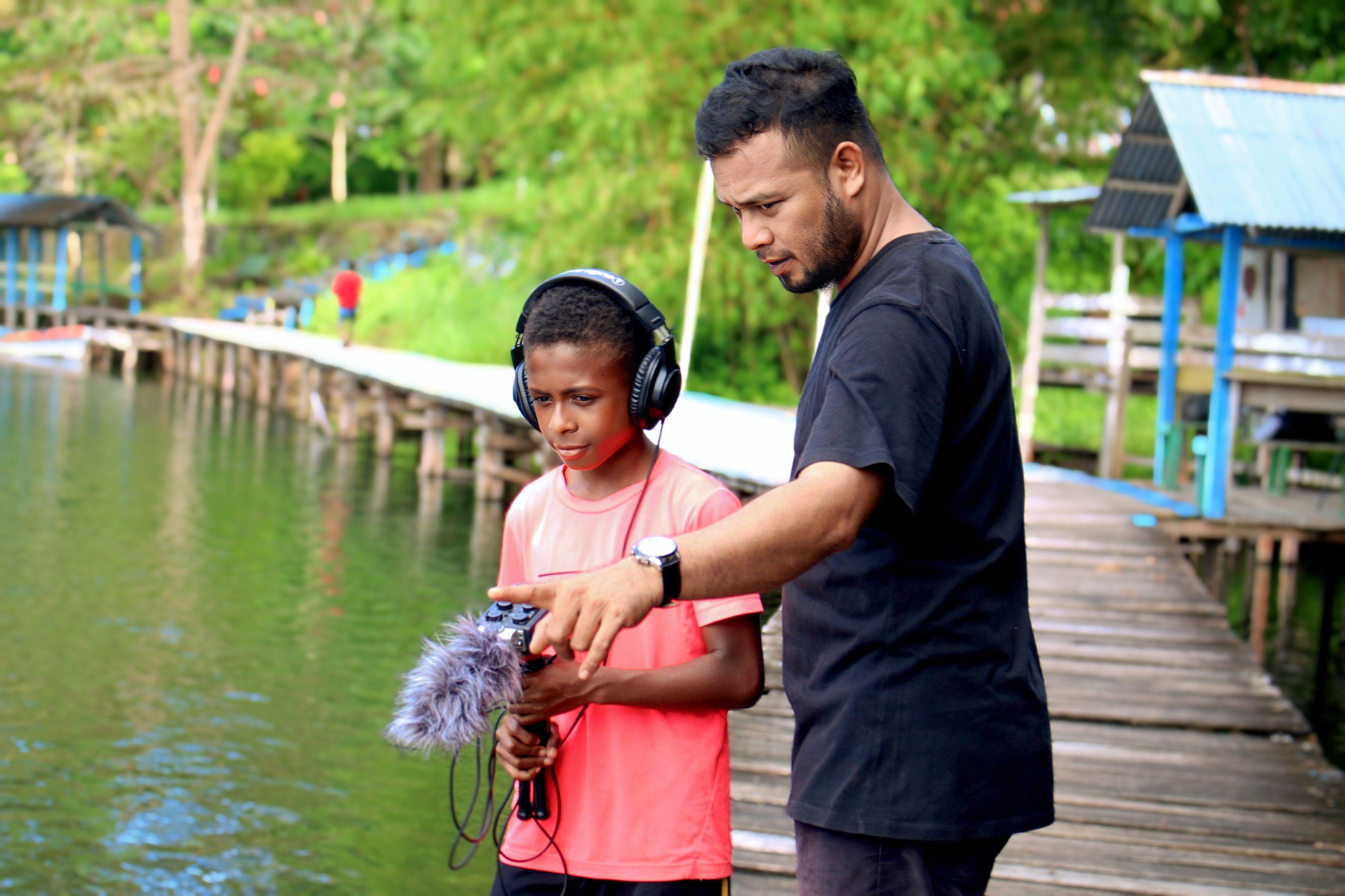 <p>Markus Rumbino with his student. Photo by Asep Nayak.</p>